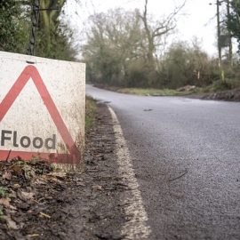 Photo of a Flood sign next to a road