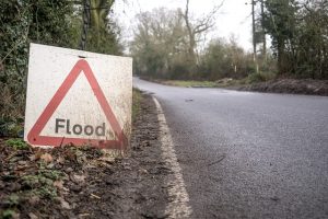 Photo of a Flood sign next to a road